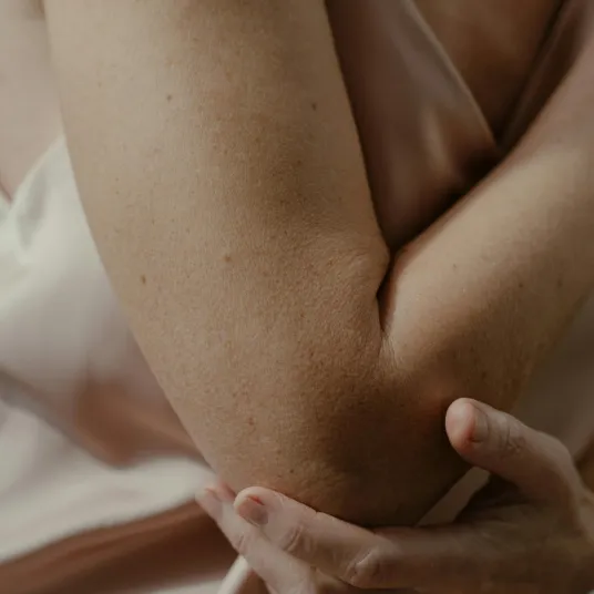 Personne se tenant le coude car elle souffre