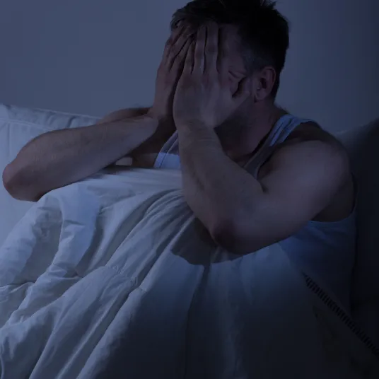 Homme dans son lit qui ne dort pas